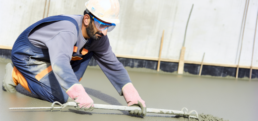 A concrete worker working with levelling floor